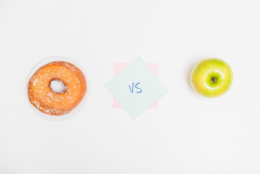 Making a decision between two choice options, a donut and an apple.