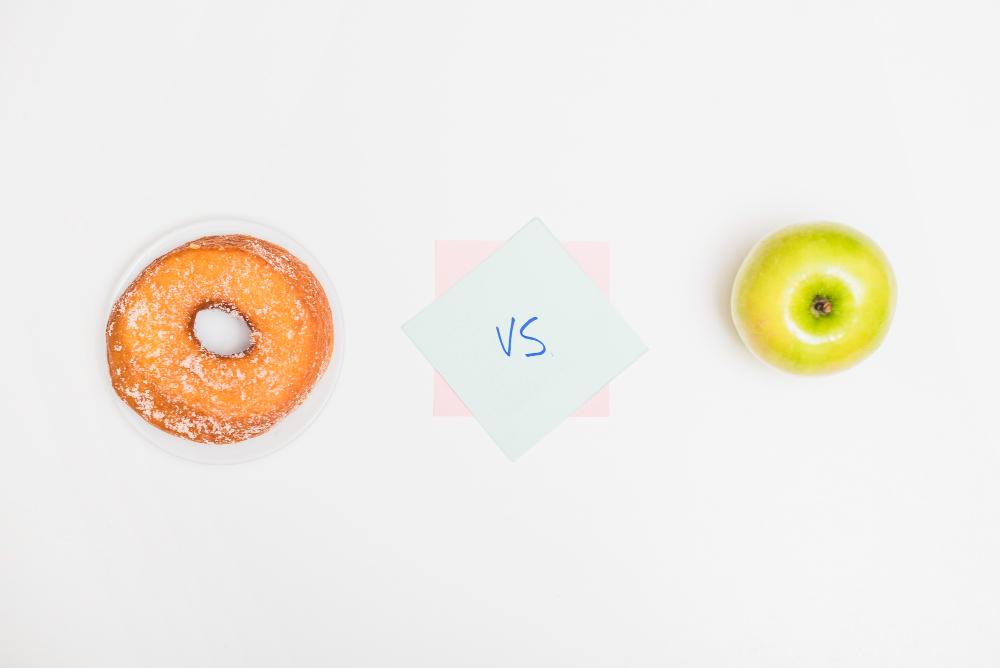 Making a decision between two choice options, illustration with a donut and apple.
